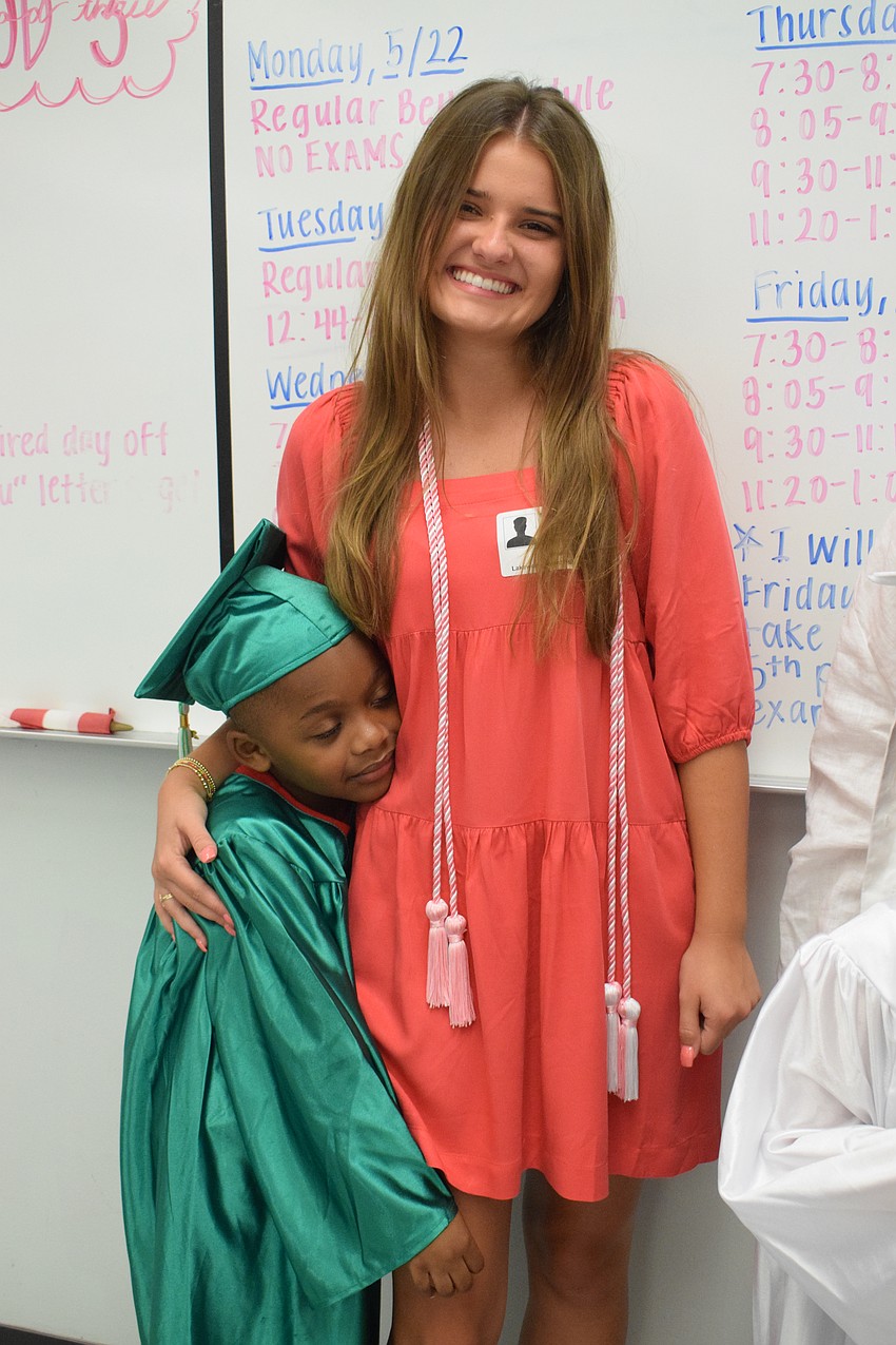 Mini Mustangs' Amir Phillips hugs Lakewood Ranch High School senior Britlee Yant.