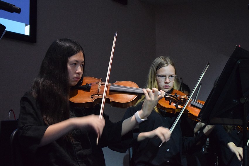 Out-of-Door Academy's Selina Zhang and Katy Fulton perform with an ensemble.