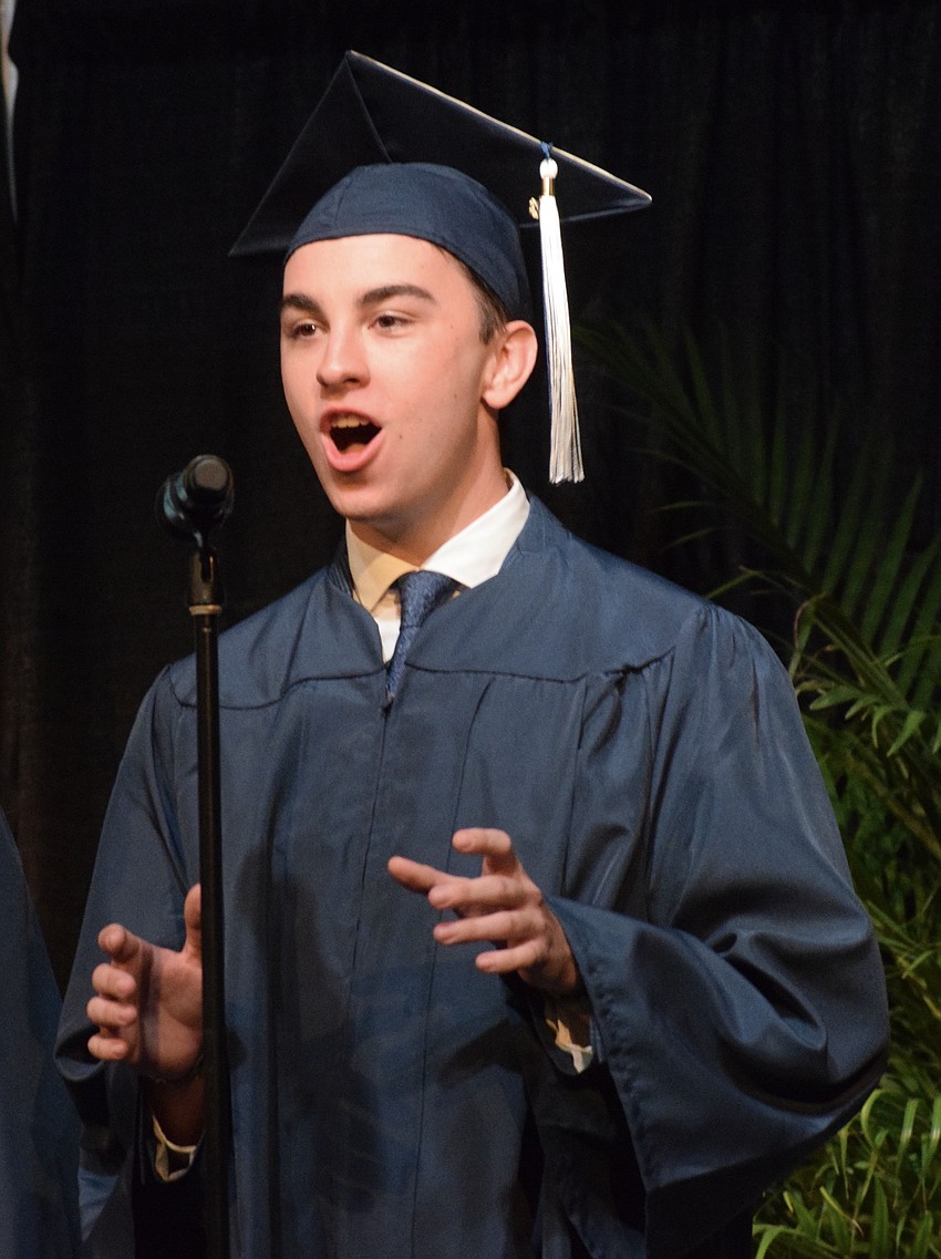 Out-of-Door Academy's Johnny Robinson gives it his all as he sings with his fellow graduates during their final performance.