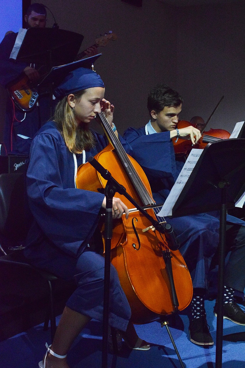 Out-of-Door Academy's Maria Shaw performs with other seniors at their graduation.