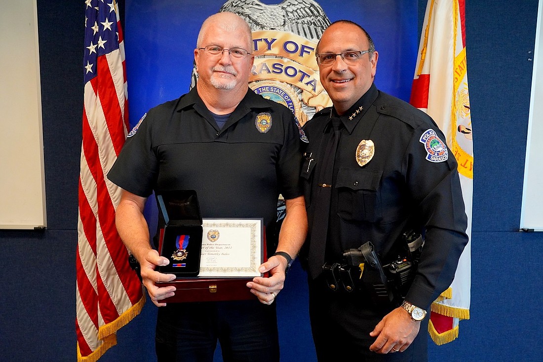 Sarasota Police Department 2022 Officer of the Year Timothy Bales with Police Chief Rex Troche.