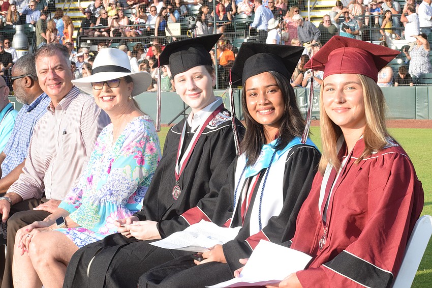 Doug Wagner, the deputy superintendent of operations for the School District of Manatee County, Superintendent Cynthia Saunders and Braden River High School's Reagan Hammond, Mahima Patel and Daliah Helfrich are ready for graduation.