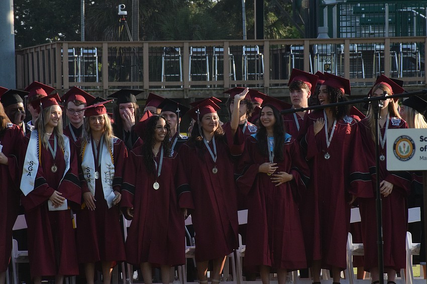 Braden River High School graduates look for their families in the crowd.