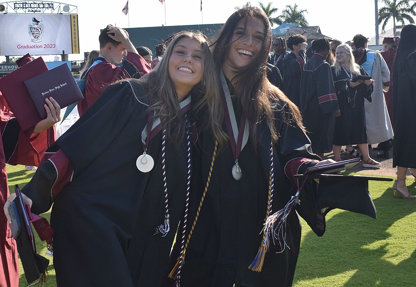 Braden River High School's Gracie Pino and Jenna Blackstone celebrate receiving their diplomas.