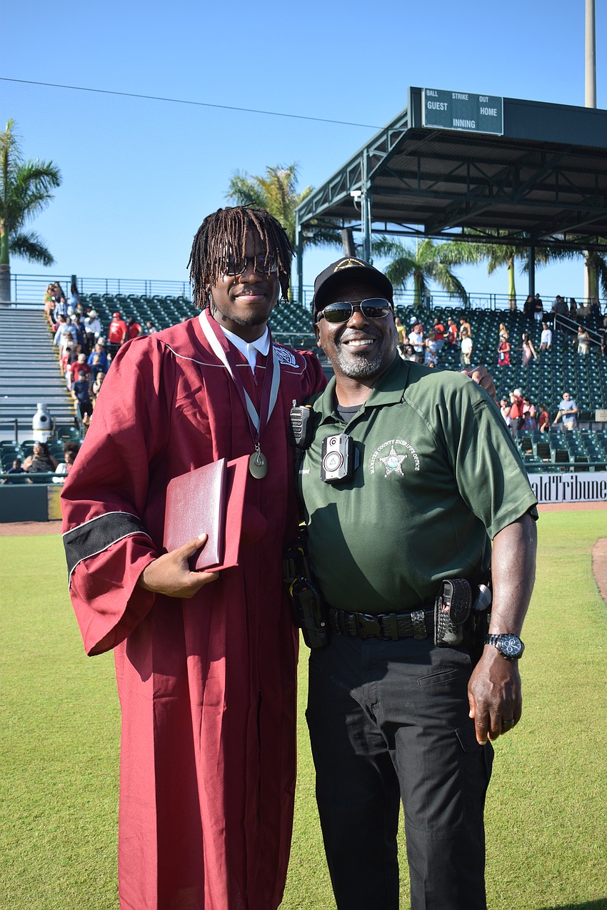 Braden River High School's Jessey Colas celebrates with Manatee County Sheriff's Office Deputy Damon Ackerman.