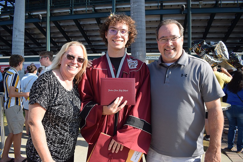 Amy Fleming congratulates her son Austin Fleming on his graduation from Braden River High School with her husband, Alex Fleming. 
