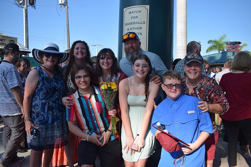 Braden River High School's Skylar Alsum (center) celebrates her graduation with her family.