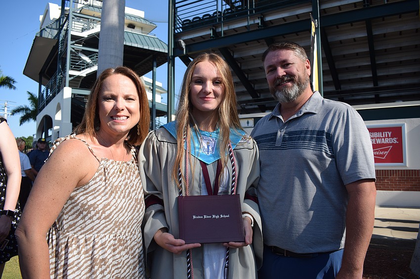 Alison McLeod celebrates her daughter Ava McLeod's graduation from Braden River High School with her husband, Jason McLeod. 