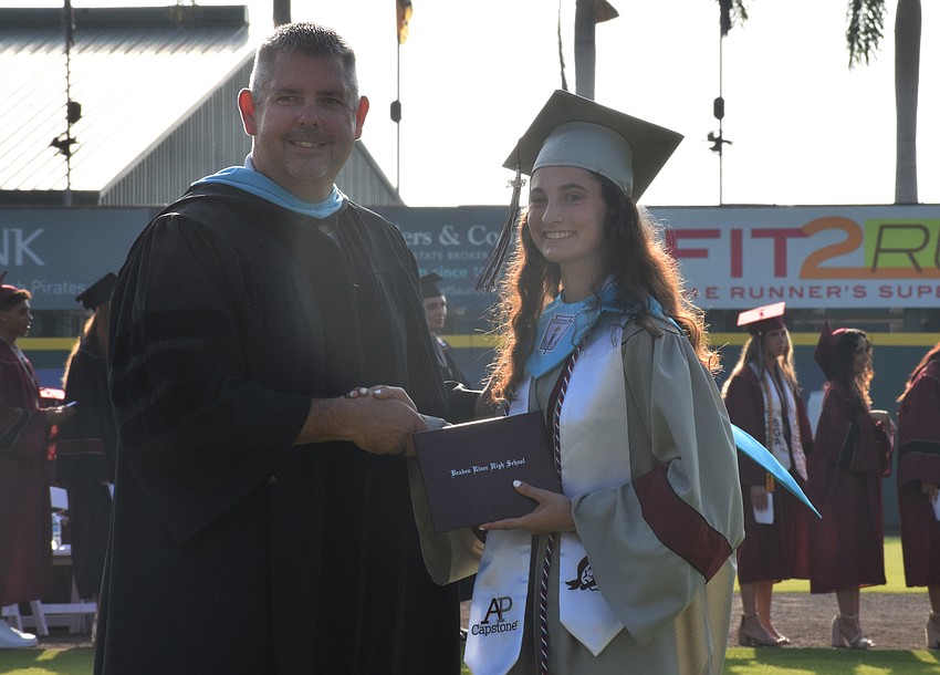 Braden River High School Principal Carl Auckerman congratulates Isabella Pasquale.