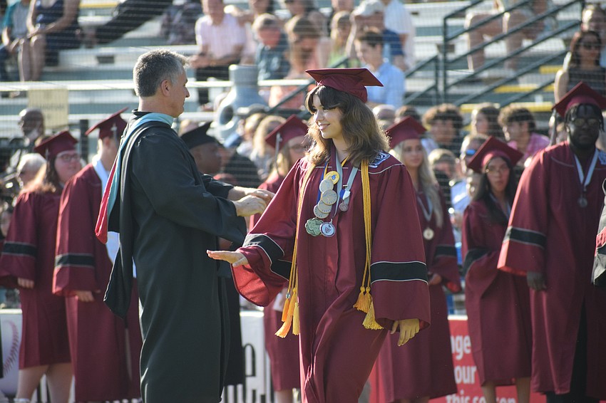 Braden River High School's Kennedy Lollar waves to her friends.