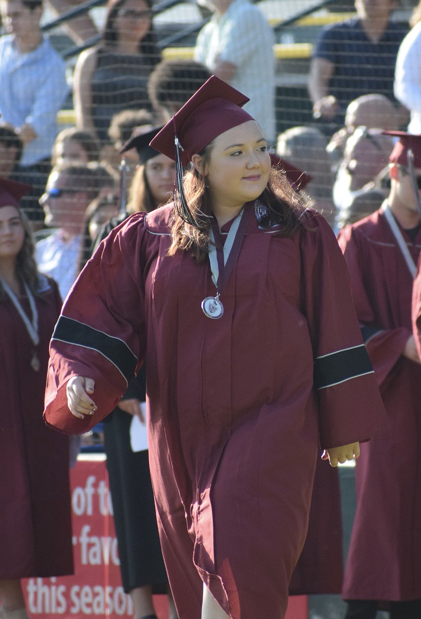 Braden River High School's Shelby Henry looks to her family in the crowd before receiving her diploma.