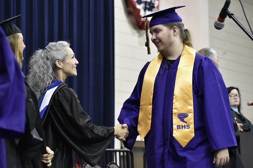 Sarasota County High School and Booker High School Teacher of the Year Courtney Smith greets Caleb West.