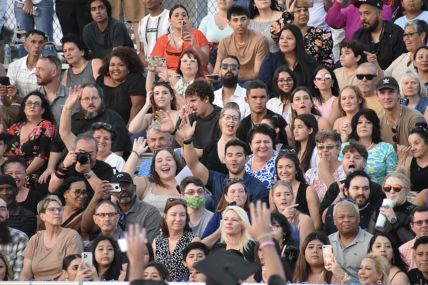 Graduates are greeted by parents in the stadium.