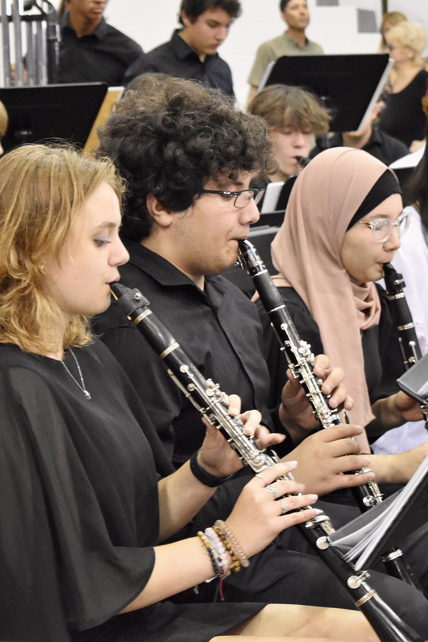 Students Madison Baird, Jacob Lirio, and Andaryia Takenova play a medley of music from Star Wars, E.T. the Extra Terrestrial, and more prior to the ceremony.
