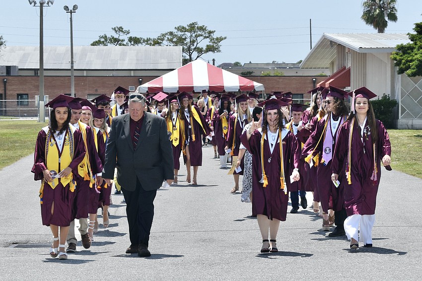 Graduates walk towards the auditorium.