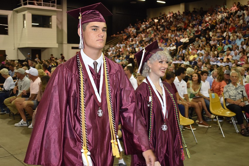 Adam Blizzard and Chloe Boggs proceed to the stage.