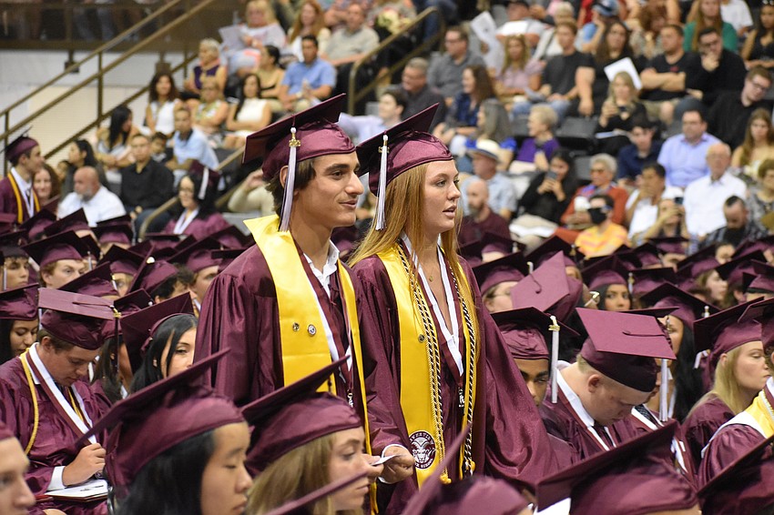 Zachary Rubin and Ava Rudd proceed towards the stage.
