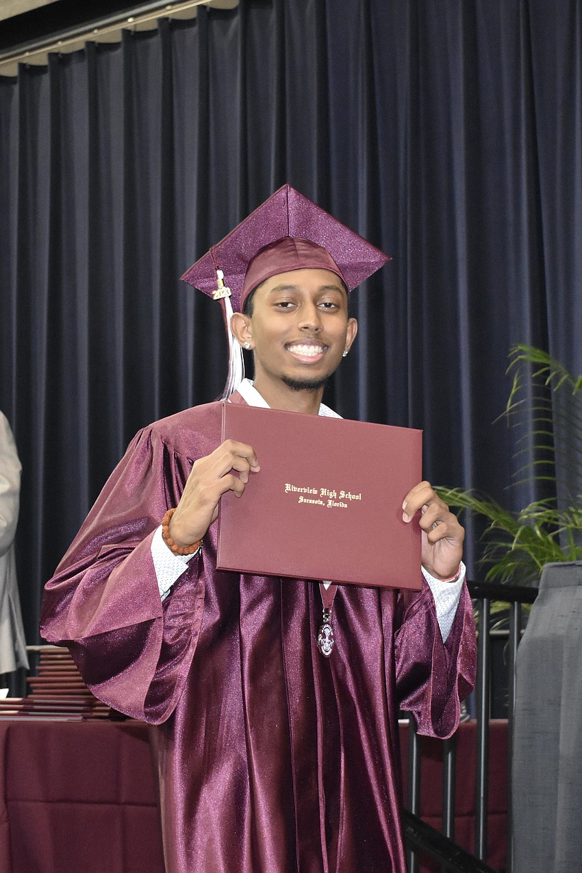 Caden Singh exits the stage with his diploma.
