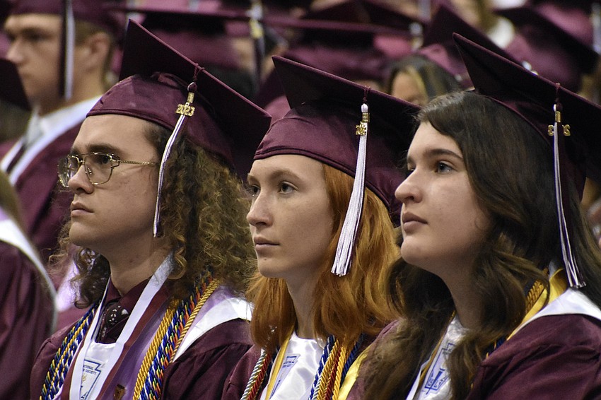 Mickeyshane McGetrick, Apollonia Krolikiewicz, and Anna Fortenberry listen to a commencement speech.