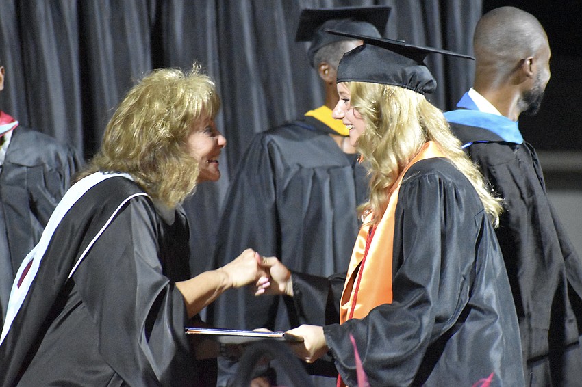School board member Robyn Marinelli greets Chloe Schale.