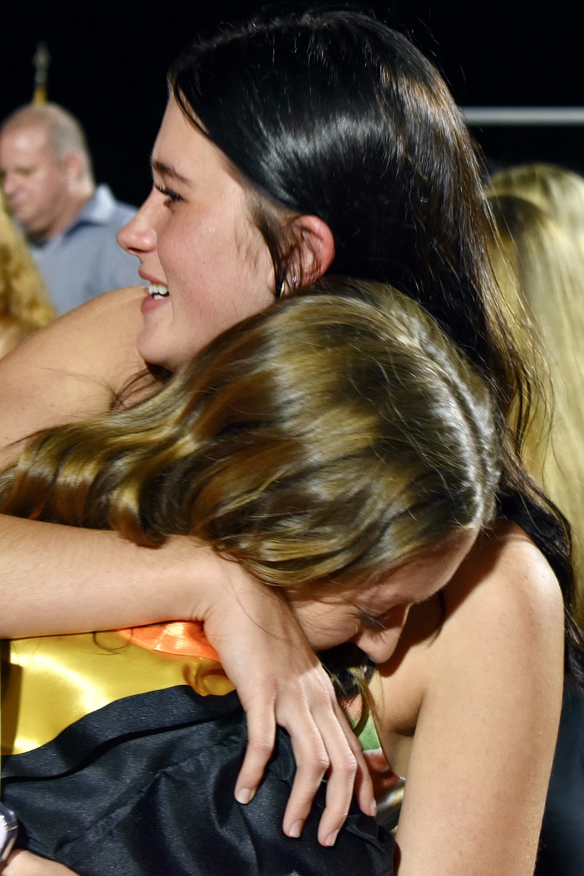 Graduate Analisa Gutierrez and her friend Taelyn Rickwa embrace, as they will not be able to spend the next year together.