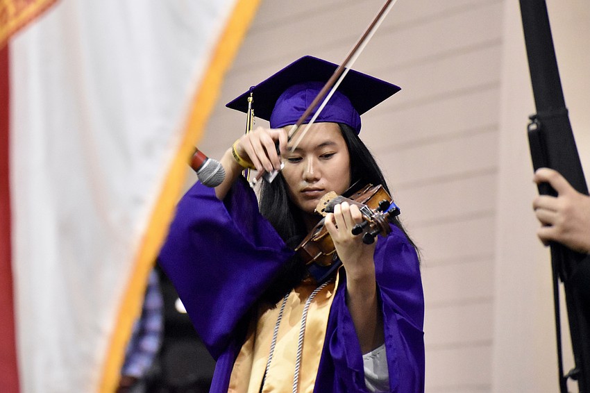 Danae Tran plays the national anthem on violin.