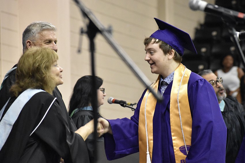 School board member Robyn Marinelli greets Ryan Fett.