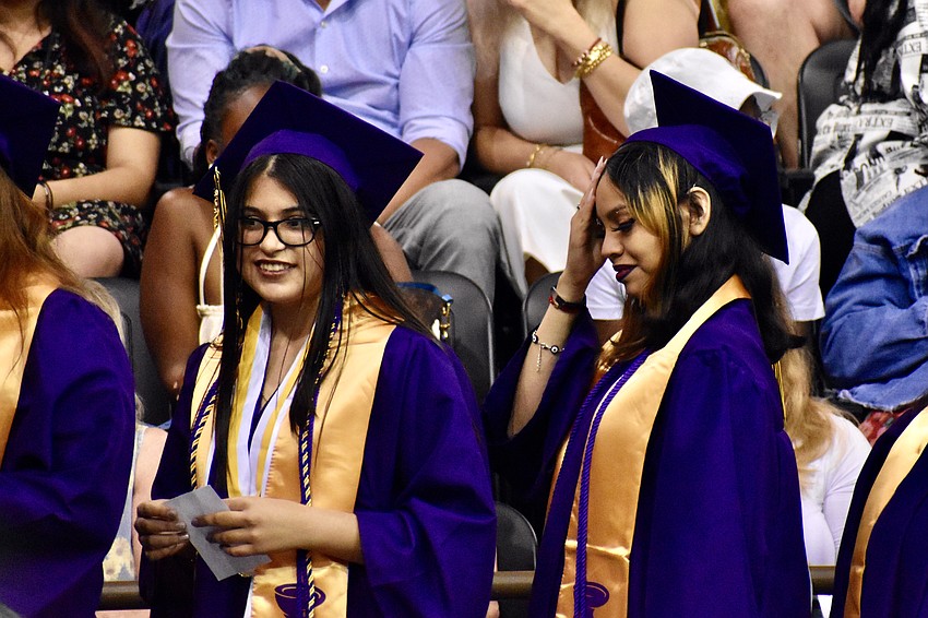 Lauren Gonzalez Gomez and Fernanda Gonazalez-Alvarado wait to receive diplomas.