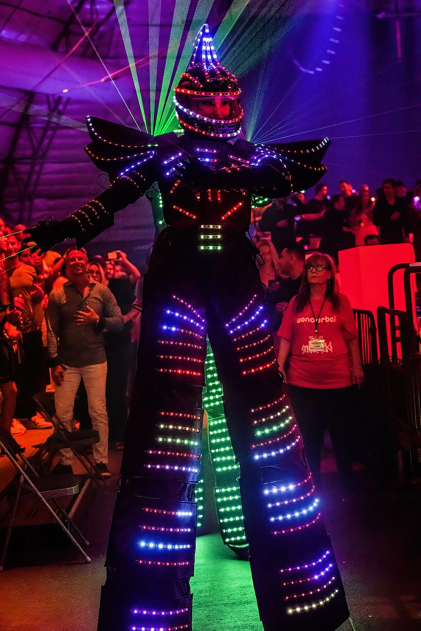 Dancers in LED costumes entertain the crowd.