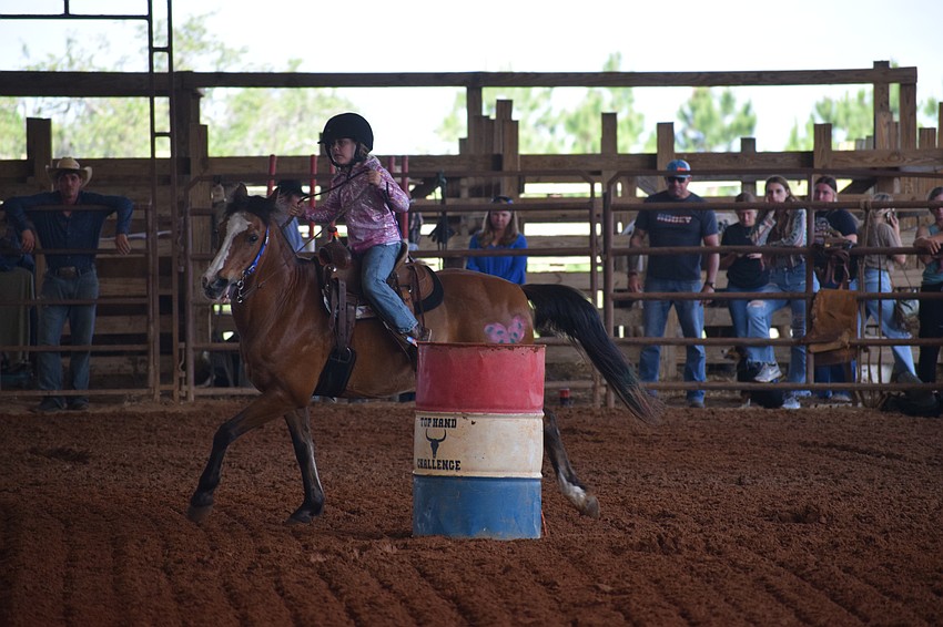 Myakka City Elementary School first grader Gwendolyn John makes her way around the barrels.