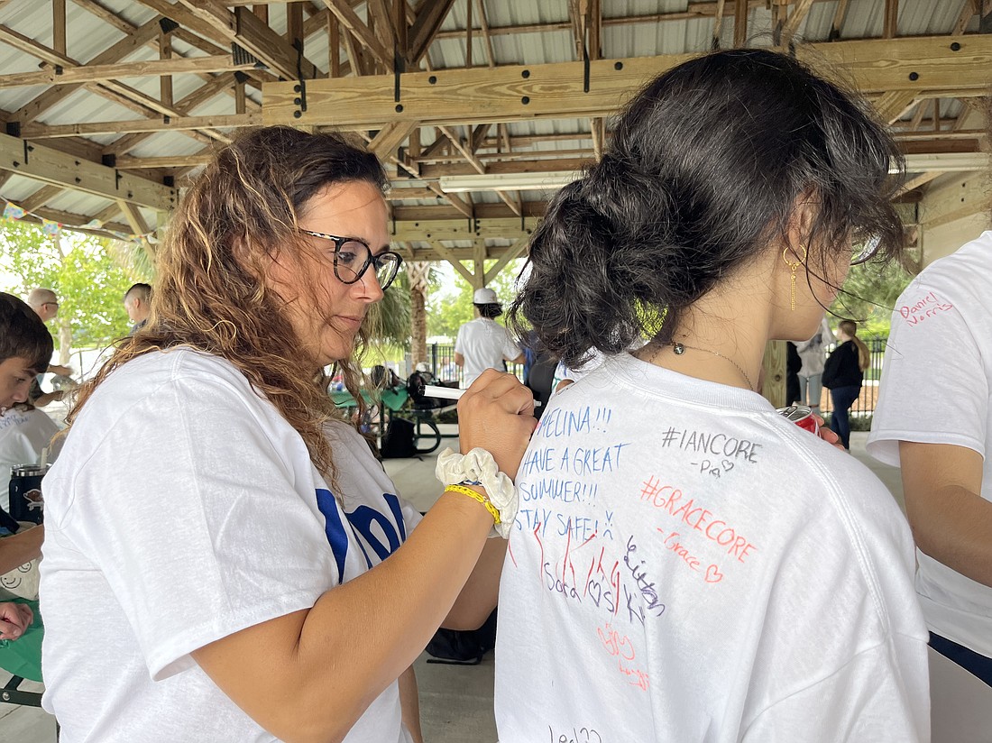 Lakewood Ranch Preparatory Academy's Nicole Durbal signs freshman Sara Johnson's T-shirt.