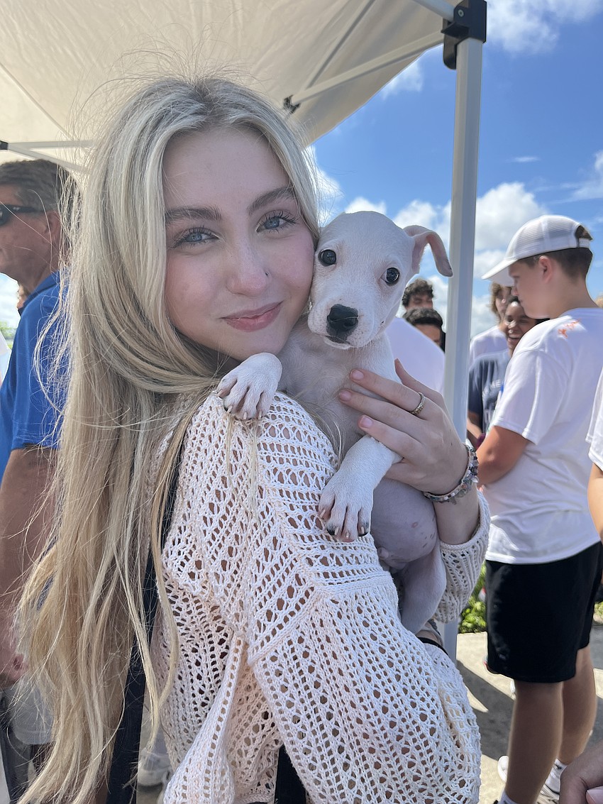 After a year of adjusting to a new school, Lakewood Ranch Preparatory Academy freshman Lina Nietz celebrates the end of the year by petting a puppy from Nate's Honor Animal Rescue.