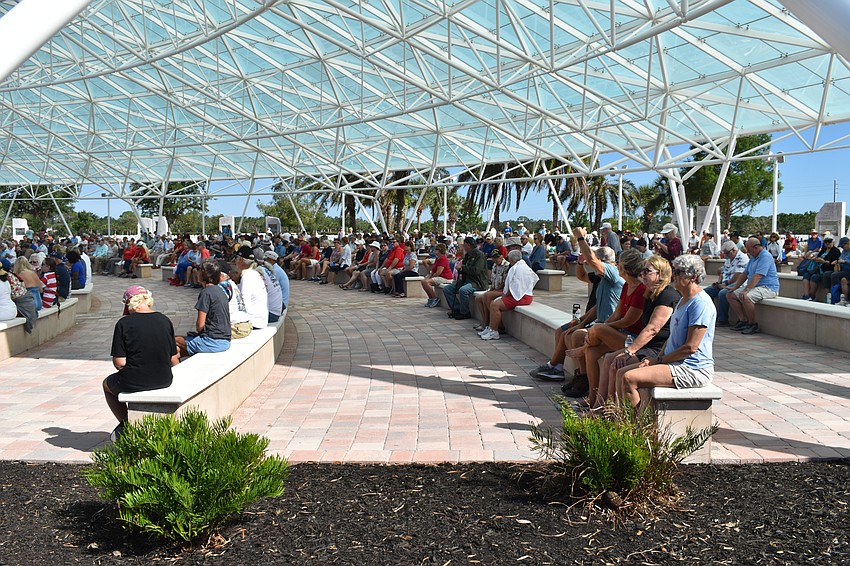 Attendees fill out the auditorium.