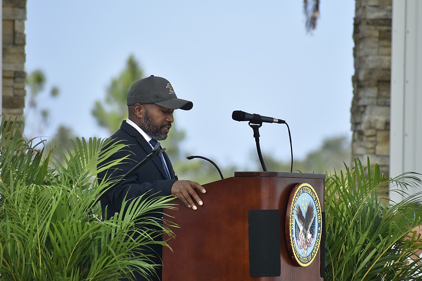 Cemetery Director Richard Wallace speaks at the podium.