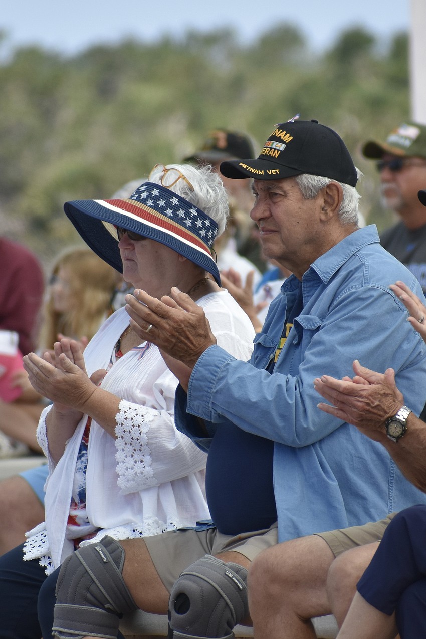 Diane Wallace and Jim Wallace applaud a speaker.