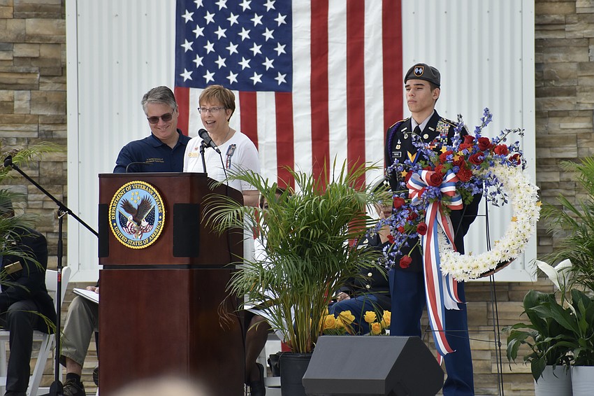Kim and Steven Hayes speak in honor of Steven Taylor Hayes, alongside Sarasota Military Academy cadet Raphael Fabyanic.