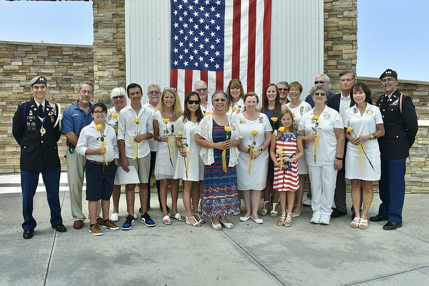 The event's Gold Star families are bordered on each side by Sarasota Military Academy cadets Raphael Fabyanic and Akiel Reyes Melendez.
