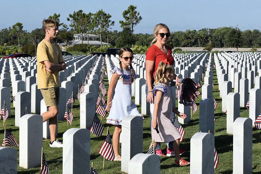 Litton, Greenly, Morgan, and Fallon Gabrielson help make sure there is a flag at each grave.