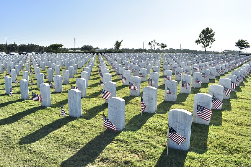 Flags sit at the graves throughout Sarasota Memorial Cemetery.