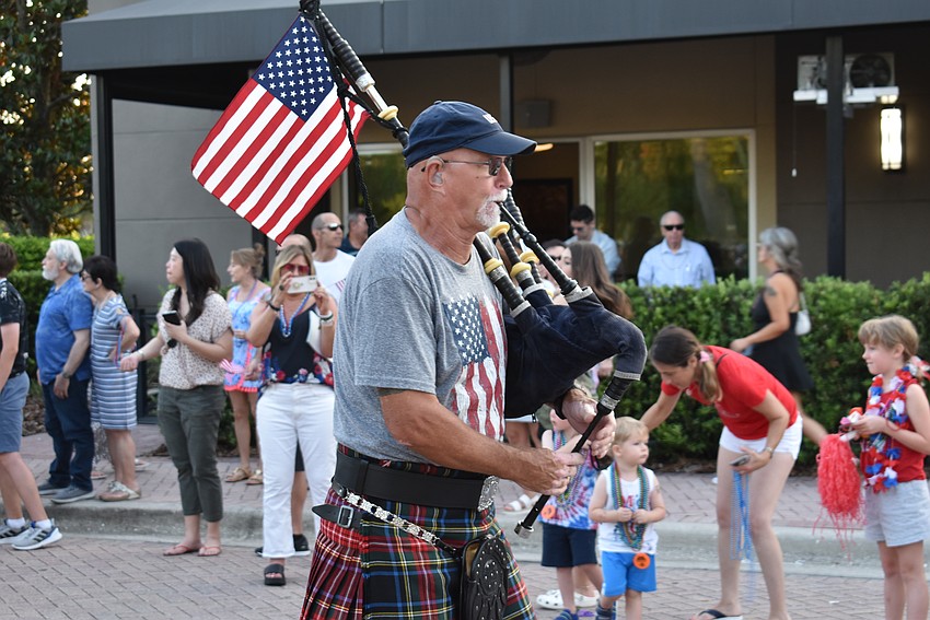 Bill Howard, the founding member of the New World Celts, plays the bagpipes during the parade.