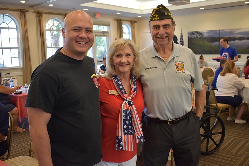 Manatee County Commissioners Jason Bearden and Vanessa Baugh visit with Herman Martinez of the Association of Veterans and Military Supporters at Del Webb at a special dinner for veterans before the parade.