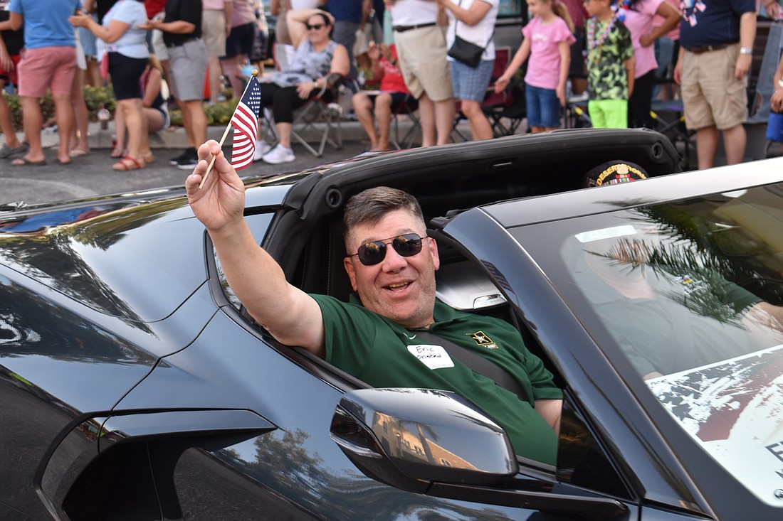 U.S. Army veteran Eric Onstad of Lakewood Ranch waves while riding in Lakewood Ranch's 2023 Tribute to Heroes Parade.