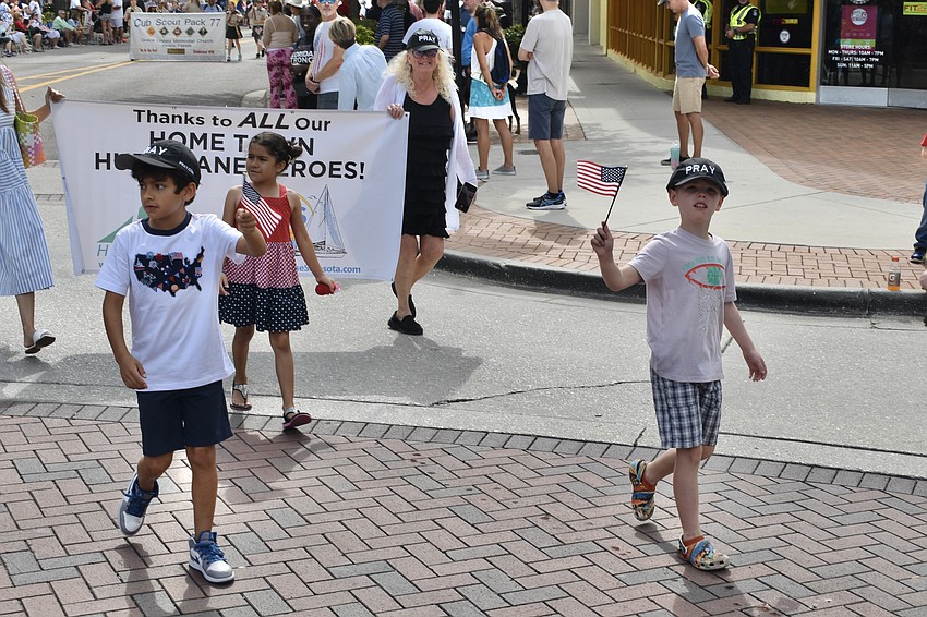 9-year-old Alejandro Bringas, 8-year-old Anabela Bringas, Jan Hamel Solomon of Sailing Home Sarasota, and 8-year-old Radley Pappo march with Hope Fleet in order to thank hurricane heroes.