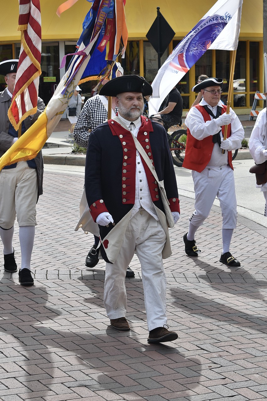 Steve Fields, president of Sons of the American Revolution for the State of Florida, leads the members of the organization.