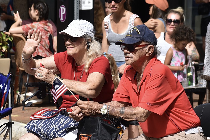 Barbara Harvey and George Harvey, a Korean War veteran who was a member of the Seabees (United States Naval Construction Battalions), watch the parade.