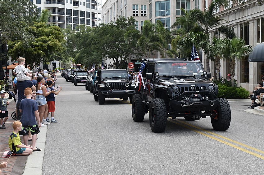 A parade by local jeep clubs stretches across Main Street.
