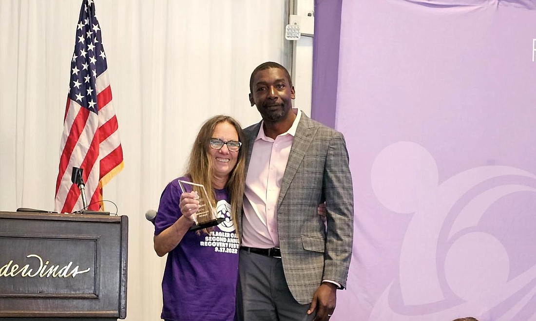 Pam Birtolo, executive director of Flagler OARS, accepts a Recovery Leadership Award from Robert Cooper, the CEO of Zero Hour Life, at the Floridians for Recovery Leadership Summit on May 15.