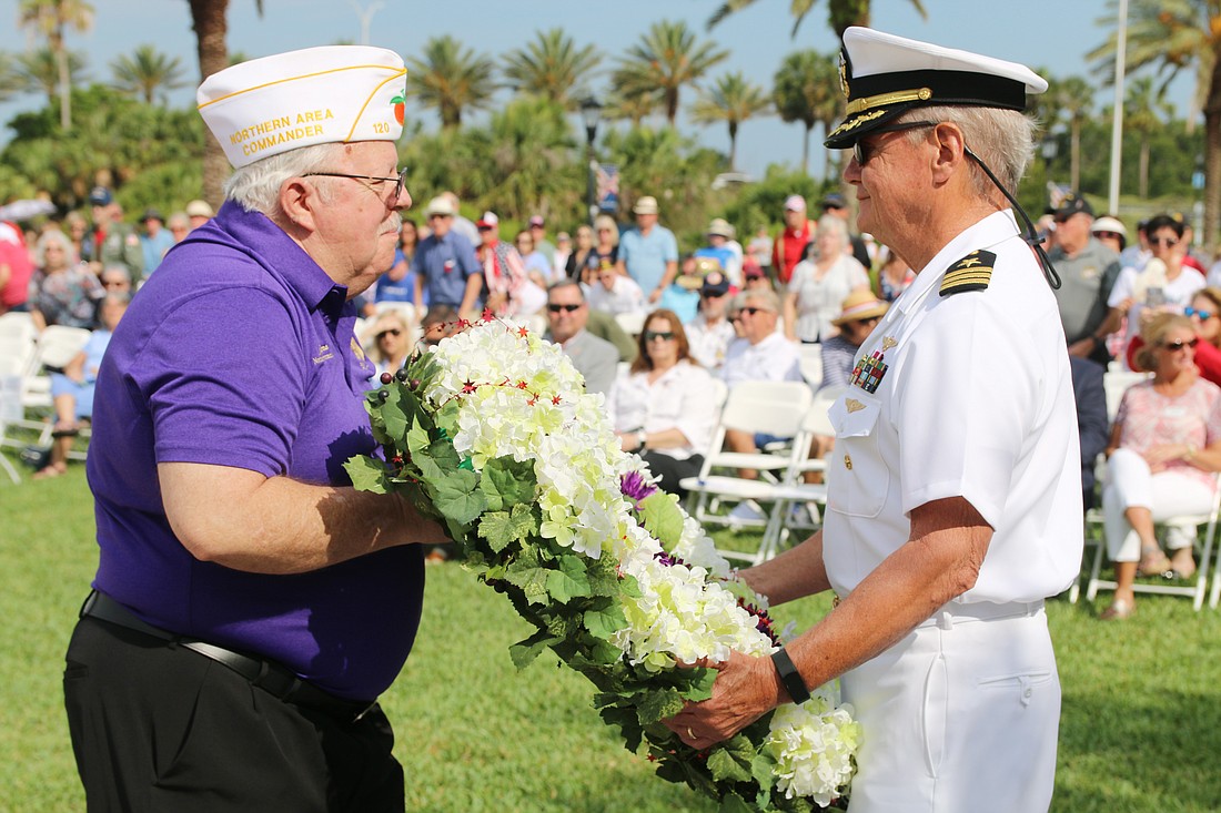 Jim Bowers and  Cmdr. John Higgins place the first ceremonial wreath during the city's annual Memorial Day Remembrance Service. Photo by Jarleene Almenas