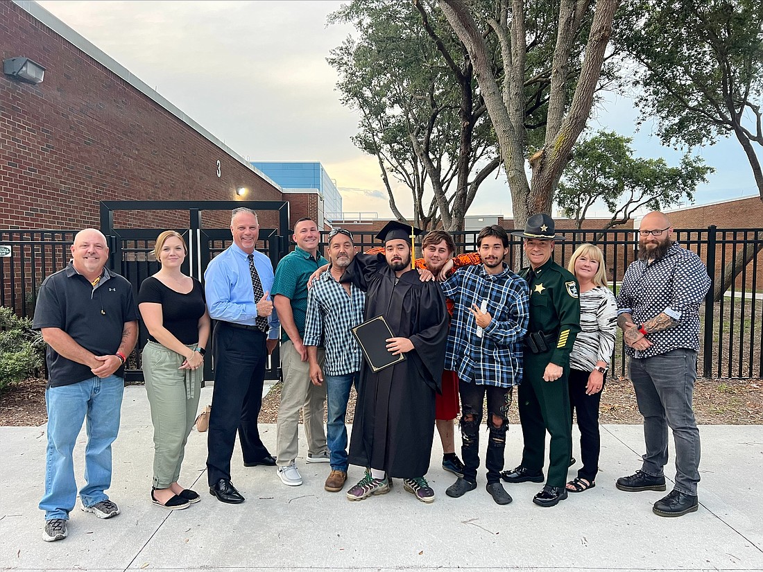 Easton Perez, a county inmate, celebrates with his family and Flagler County Sheriff's Office employees. Perez is the first inmate to graduate from the jail's GED program. Photo courtesy of the FCSO.