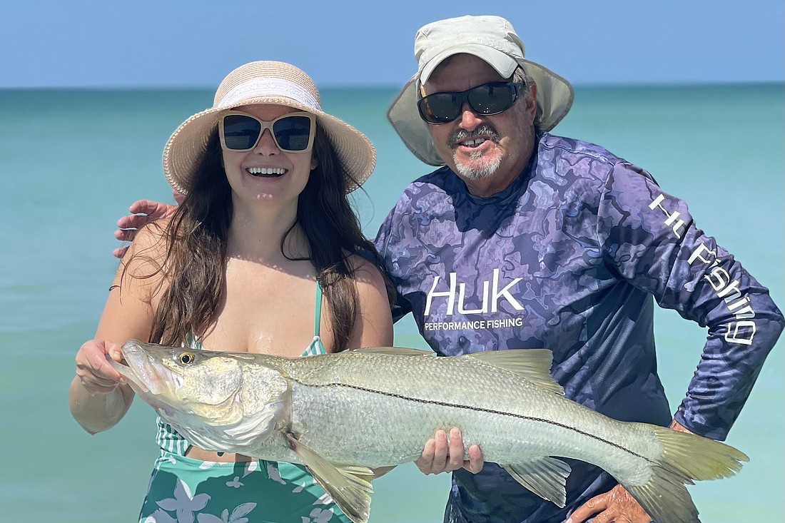 A client and Steven Herich catch a snook.